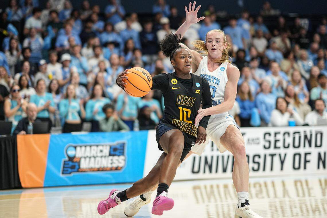 Jordan Harrison of the West Virginia Mountaineers drives past Lexi Donarski of the North Carolina Tar Heels during the first half in the second round of the NCAA Women's Basketball Tournament at Carmichael Arena on March 24, 2025, in Chapel Hill, North Carolina.