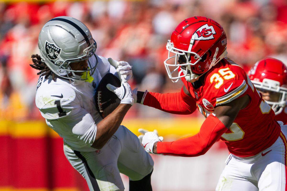 Chiefs cornerback Jaylen Watson, right, makes a tackle on Las Vegas Raiders wide receiver Tre Tucker during an NFL Week 7 game on Sunday, Oct. 19, 2025 at GEHA Field at Arrowhead Stadium.