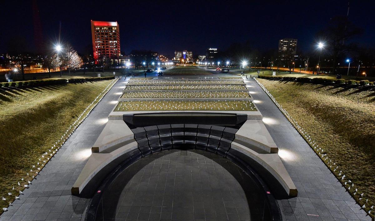 People who lost their lives to COVID-19 were remembered and frontline workers were honored on the National Day of Remembrance Tuesday, Jan. 19, 2021. A white flag for each of the 1,665 people who died of COVID in the Kansas City metro area was planted in front of the National World War I Museum and Memorial and the city skyline was lit in amber. This coincided with ceremonies across the country.
