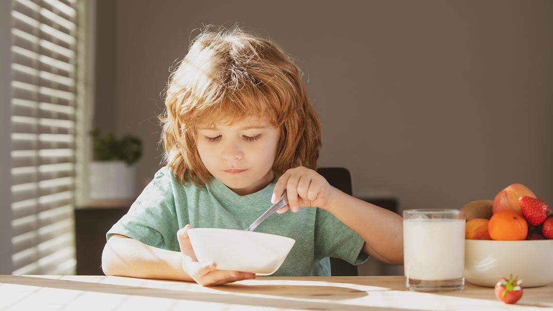Child eat. Little healthy hungry kid eating soup from with spoon. hunger nutrition food assistance food aid