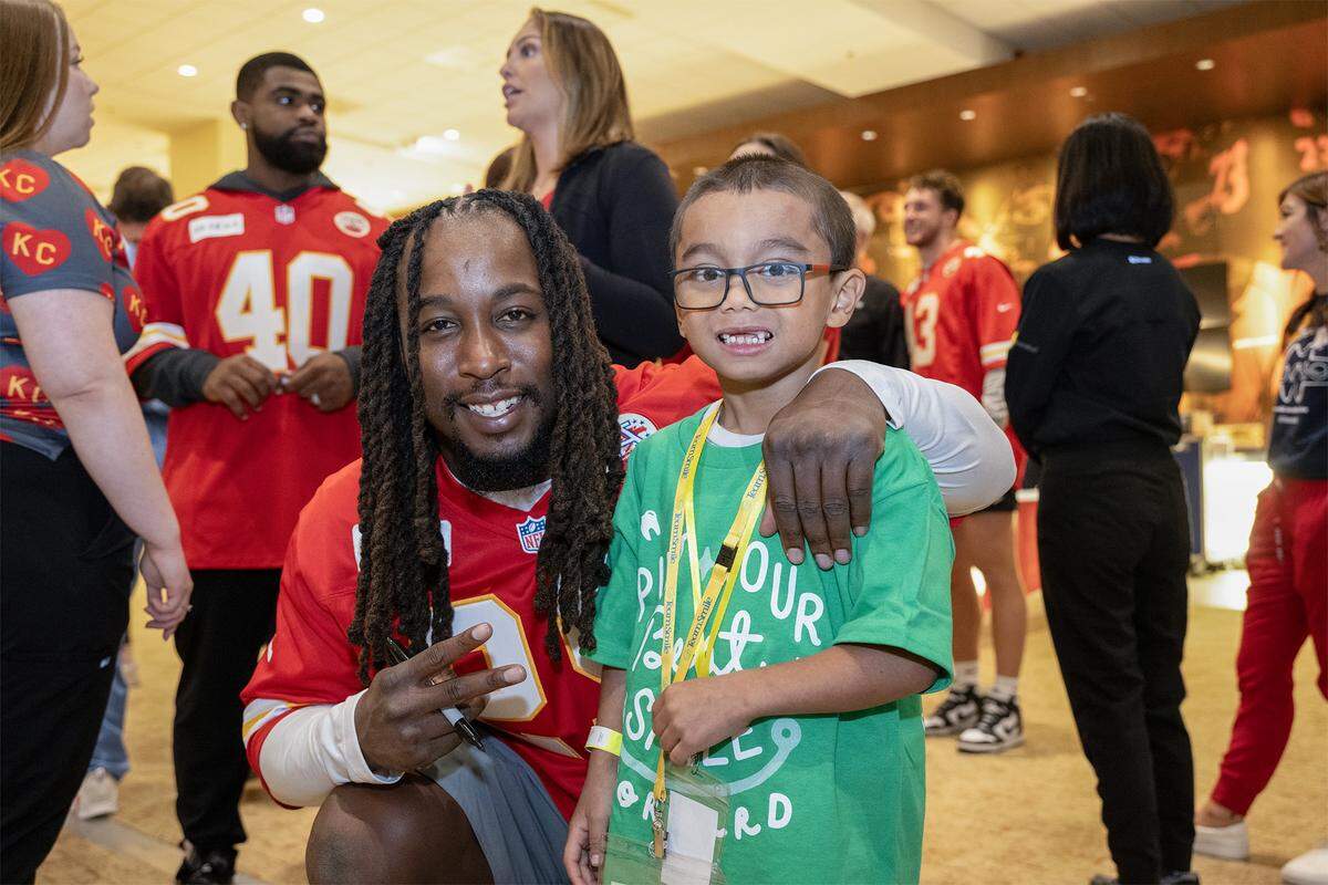 Kansas City Chiefs running back Kareem Hunt took a photo with Austin Le, 6, after Austin had some free dental work done at the TeamSmile dental tailgate on Tuesday, Sept. 9, 2025 at GEHA Field at Arrowhead Stadium.  More than 200 volunteer dentists, hygienists, and dental assistants provide the care backed by TeamSmile and the Chiefs. 