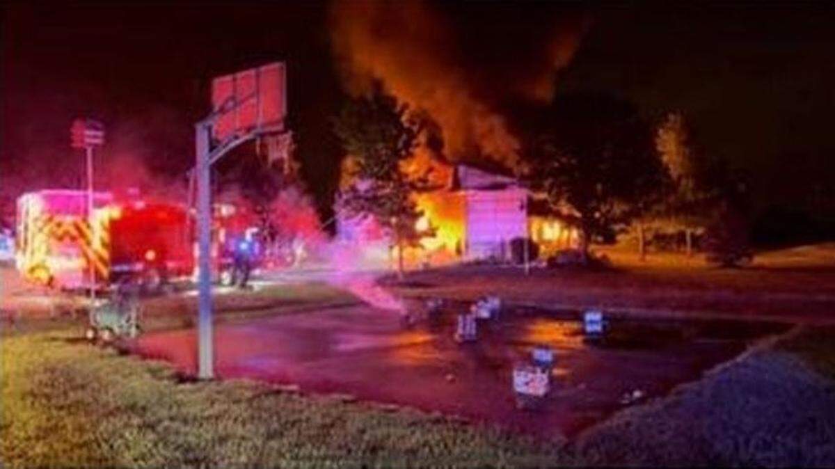 Rescuers dragged four people to safety after they were injured when fire consumed an outbuilding causing fireworks to explode Saturday night south of De Soto in rural Johnson County, Kansas.