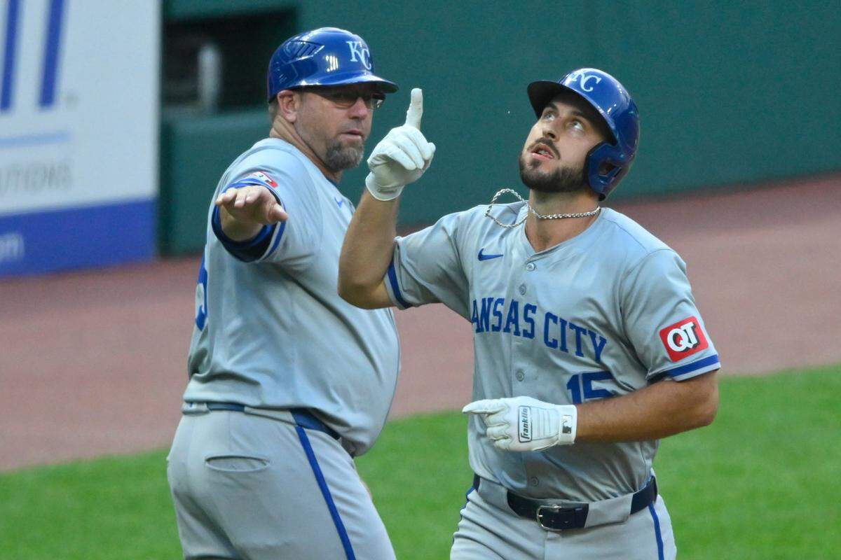 Kansas City Royals third baseman Paul DeJong (15) celebrates his two-run home run with third base coach Vance Wilson (25) in the second inning against the Cleveland Guardians at Progressive Field on Aug 27, 2024 in Cleveland, Ohio, USA.