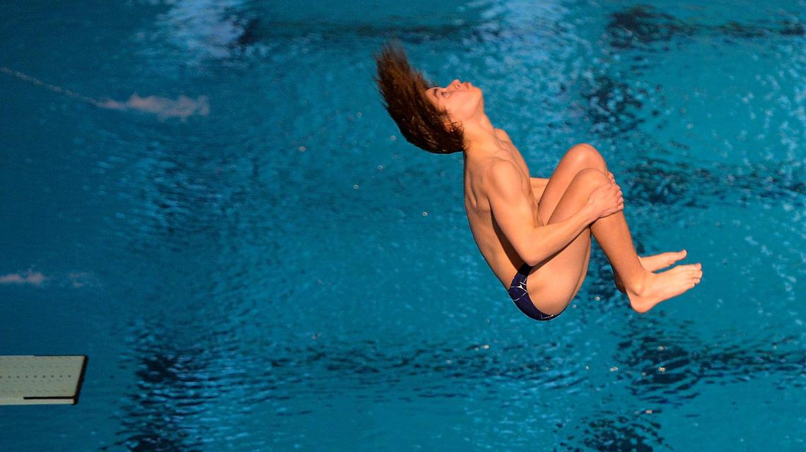 Olathe West junior Aiden Rafols flips of the board in the one-meter diving competition Friday, February 19, 2021, at the 6A Kansas Boys State Swimming and Diving Championships in Lenexa.