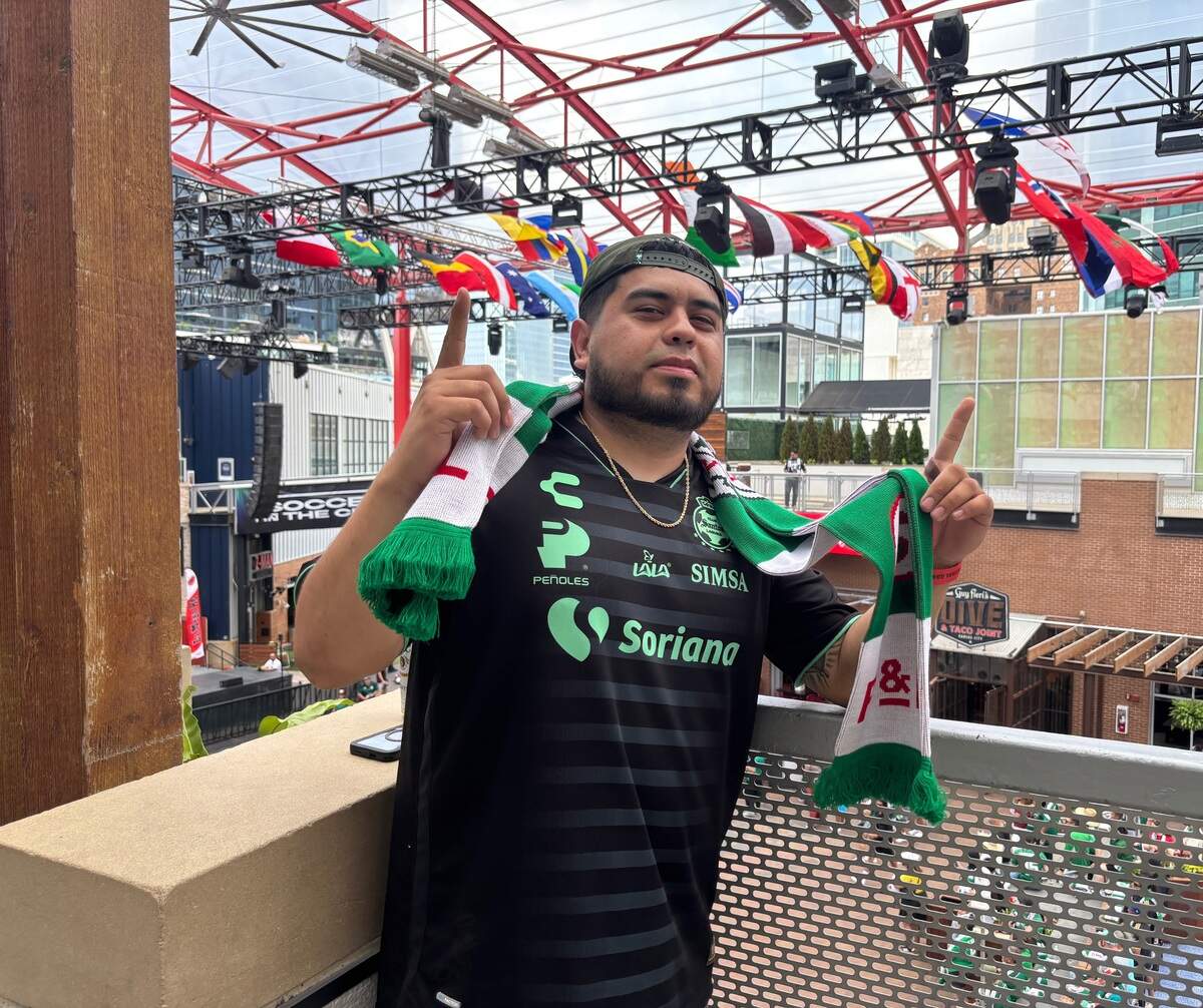 Jay Toon shows off his Mexico scarf, a giveaway from the Power and Light District. The Olathe resident took off work to attend the FIFA World Cup watch party. June 11, 2026.