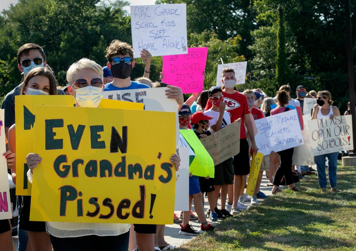 Chris Knuth, who has two grandsons at Shawnee Mission Northwest, joined parents and students protesting outside the district’s Center for Academic Achievement, 8200 W. 71st St., Overland Park on Monday, calling for in-person classes and the restart of sports programs.