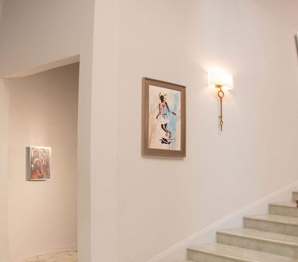 One of Jason Wilcox’s paintings hangs in the foyer of the “Bel-Air” mansion.