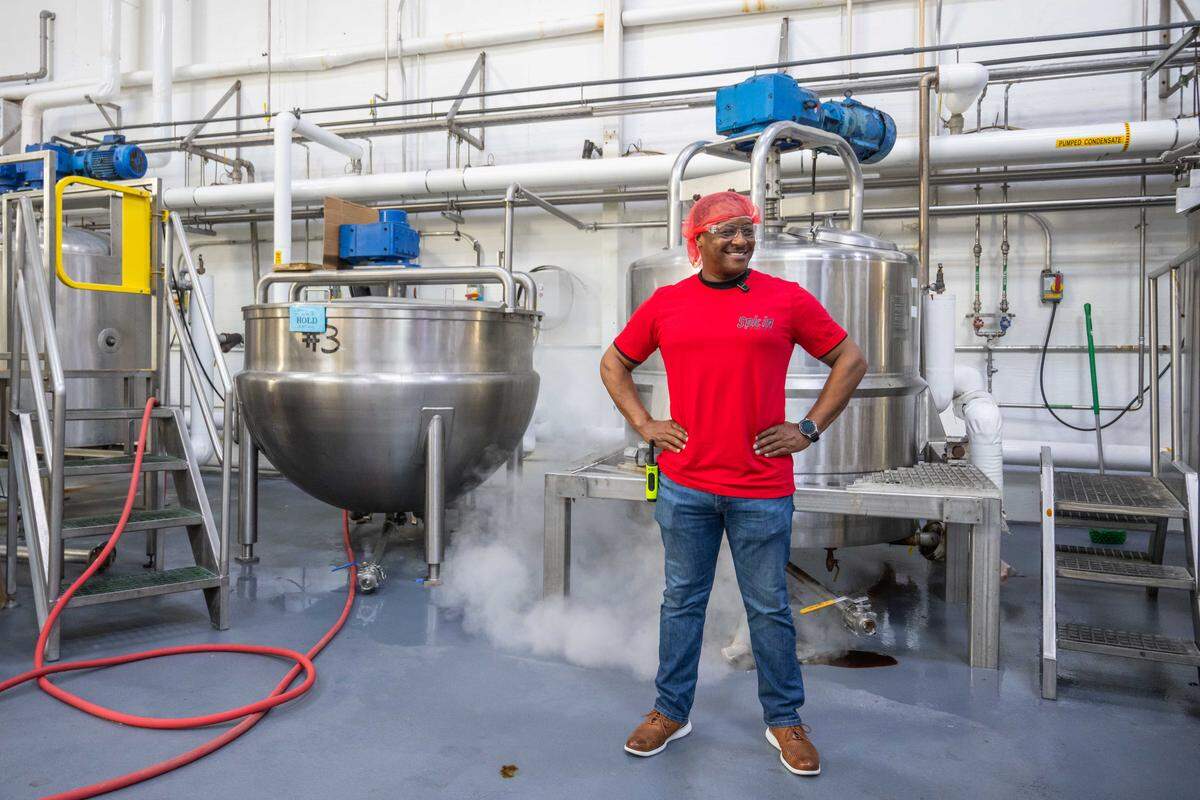 Spicin Foods Chief Operations Officer Arnandas Giles on the production floor at the Spicin Foods warehouse on Southwest Boulevard, on October 2, 2025, in Kansas City. “There's a whole culture around hot sauce and people wanting to burn themselves out. I don't understand it, but I'm glad they do because they keep us in business,” says Giles.