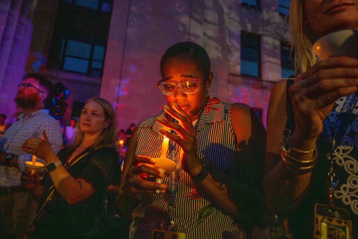Judge Candice Alcaraz watches her candle during a candlelight vigil held for Elijah Ming outside the Wyandotte County Courthouse on Wednesday.
