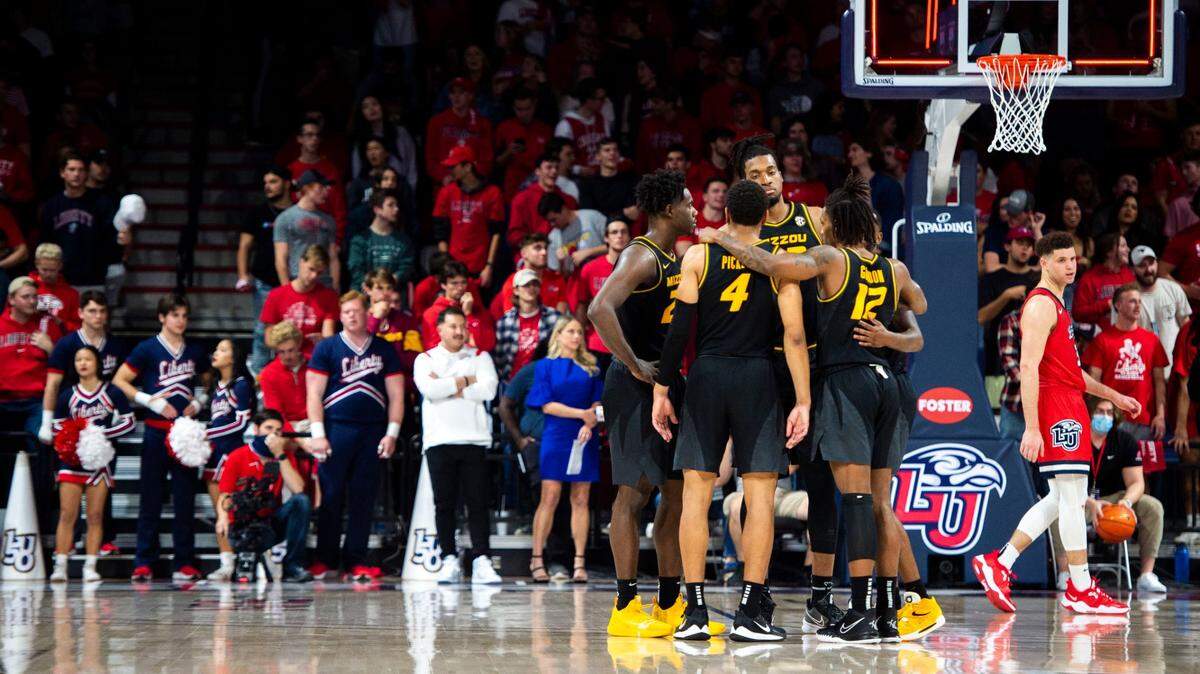 Missouri players huddle on the court during an NCAA college basketball game against Liberty on Thursday, Dec. 2, 2021, in Lynchburg, Va. (Kendall Warner/The News & Advance via AP)