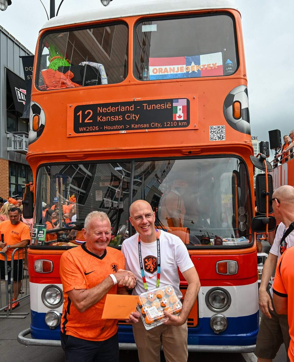 Frans Peters, left, is the driver of the famous Oranje Bus. He's been driving the bus and guiding Dutch fans for 22 years. He and the bus will be the focal point of the Netherlands Orange Walk from Kansas City's Power & Light District to FIFA Fan Fest on June 25, 2026.