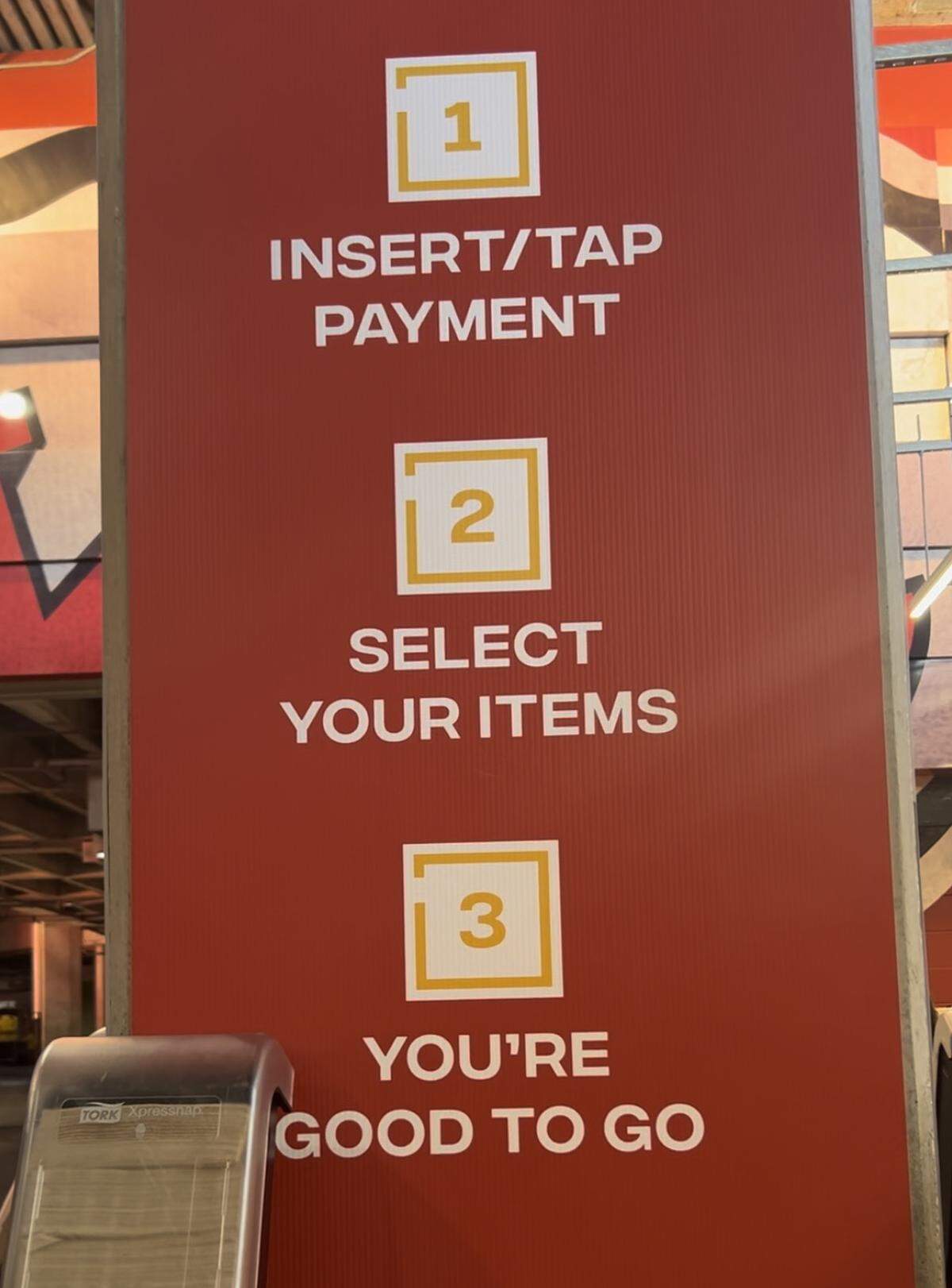 A sign at Arrowhead Stadium outlines the ordering process at Kingdom Grill, which uses cashier-less technology.