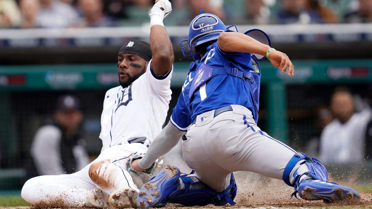 Detroit Tigers left fielder Akil Baddoo slides safely into home plate to score ahead of the tag by Kansas City Royals catcher MJ Melendez (1) in the fifth inning of a baseball game in Detroit, Thursday, Sept. 29, 2022. (AP Photo/Paul Sancya)
