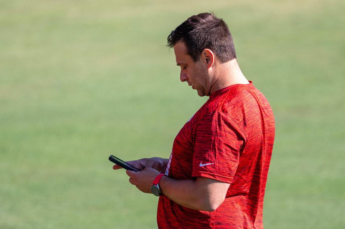 Kansas City Chiefs general manager Brett Veach checks his phone while attending practice at Chiefs training camp on Thursday, July 18, 2024, in St. Joseph.