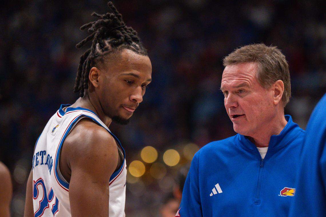 Kansas Jayhawks guard Darryn Peterson (22) talks with head coach Bill Self during a timeout in the second half vs. the Houston Cougars on Monday, February 23, 2026, at Allen Fieldhouse.