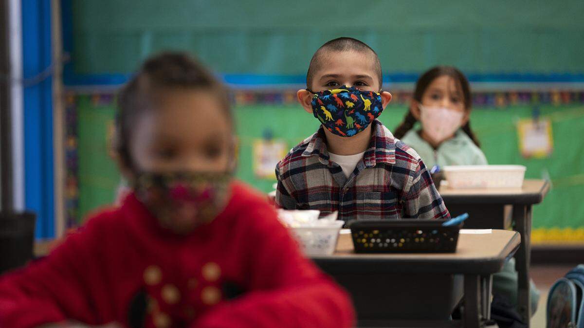 In this April 13, 2021, file photo, kindergarten students sit in their classroom on the first day of in-person learning at Maurice Sendak Elementary School in Los Angeles, California.