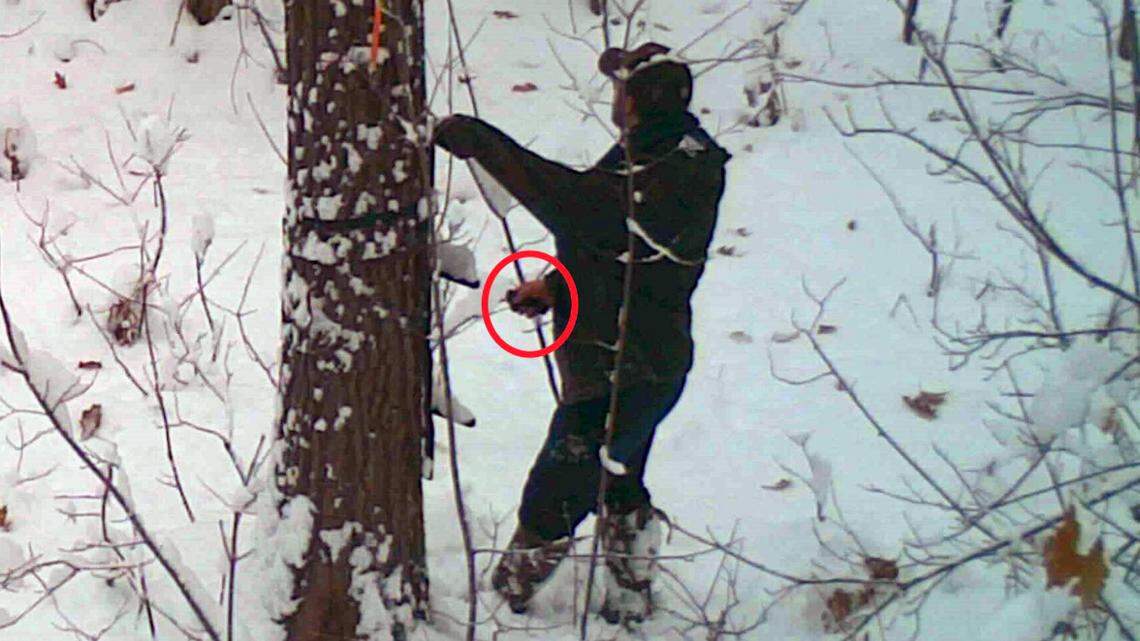 A trail camera captured a man as he sabotaged another hunter by cutting his tree stand’s straps, officials said.