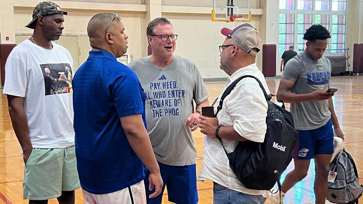KU coach Bill Self, third from left, visits with some individuals who watched Wednesday’s Jayhawks practice in Puerto Rico.