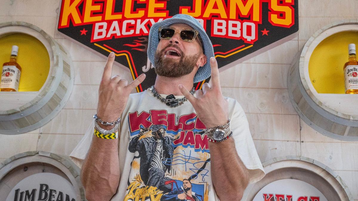 Kansas City Chiefs tight end Travis Kelce poses for photos near the Jim Beam booth during Kelce Jam at the Azura Amphitheater on Saturday in Bonner Springs, Kansas.