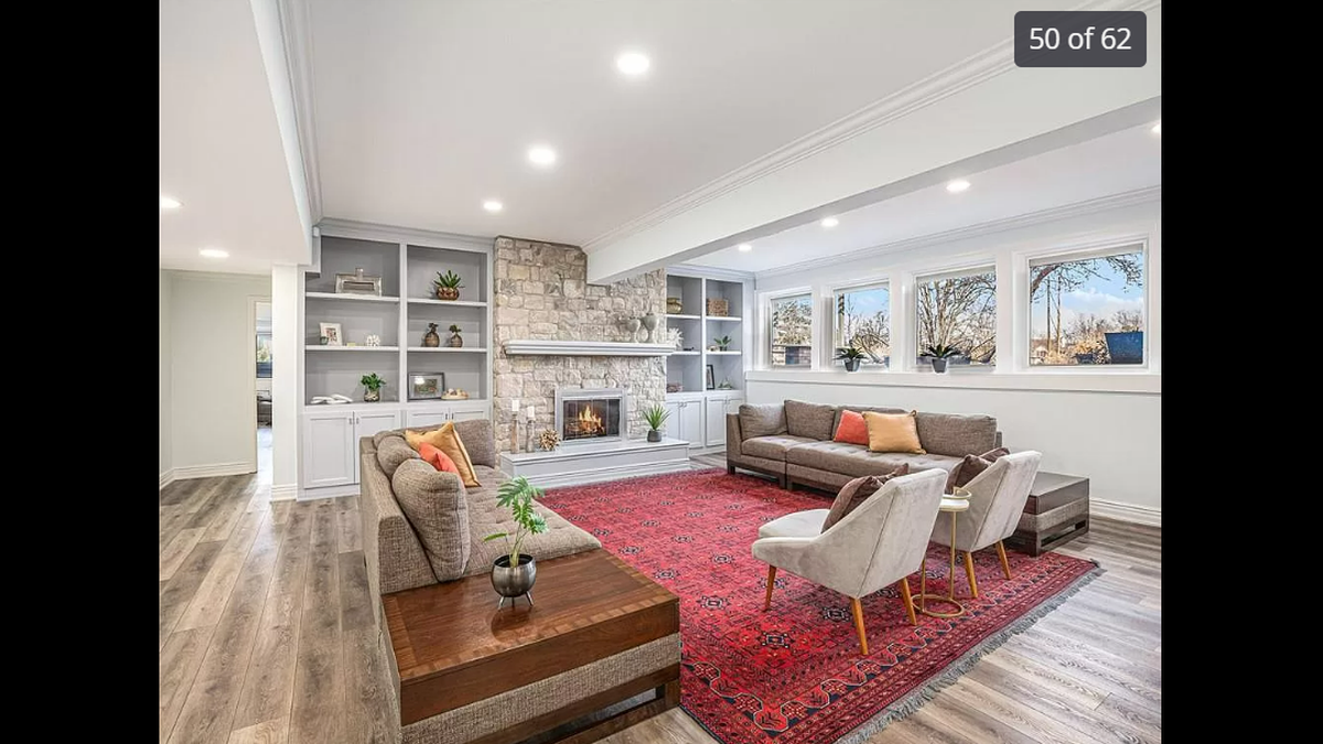 One of many lounging areas inside the home at 15525 Switzer Road in Overland Park. The lower level area gives visitors a peek at the backyard scenery.