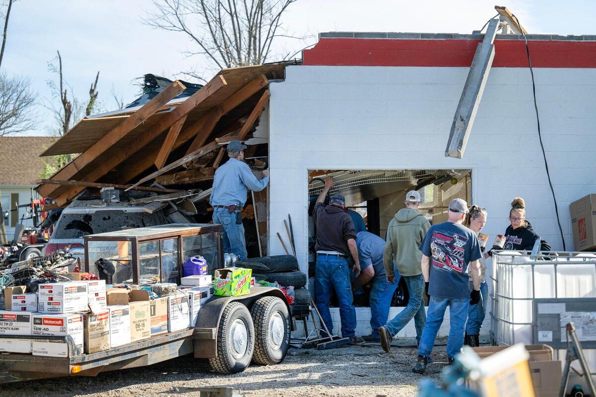 Volunteers work to recover and salvage items from the Moundville Service Station that was wiped out by a tornado on Wednesday in Moundville, Missouri, in Vernon County. .