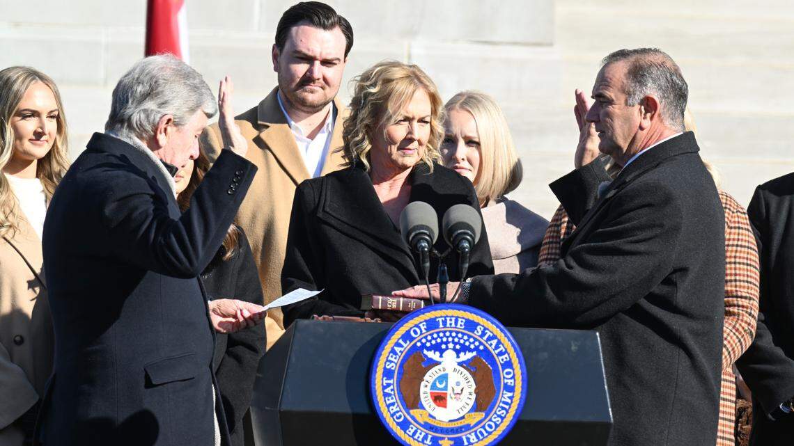 Missouri Governor-elect Mike Kehoe, right, is sworn in as governor Monday by former U.S. Sen. Roy Blunt, left, on the steps of the Missouri State Capitol in Jefferson City, With Kehoe were his wife Claudia, center, and members of his family.