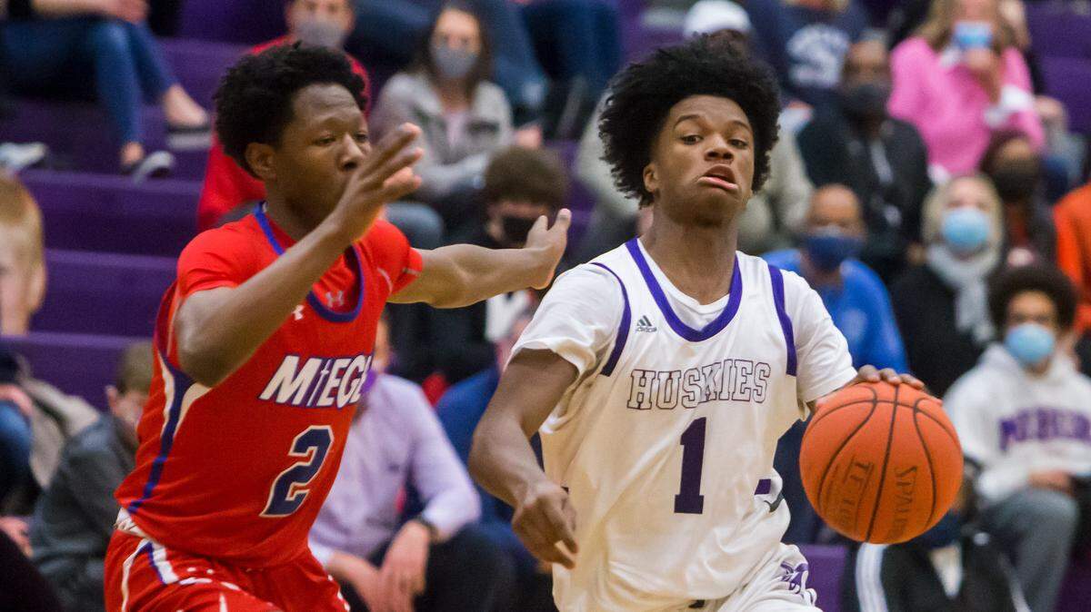 Blue Valley Northwest senior Alston Mason (right) drives past Bishop Miege junior Xavier Hall during the game at Blue Valley Northwest on Friday Feb. 26, 2021.