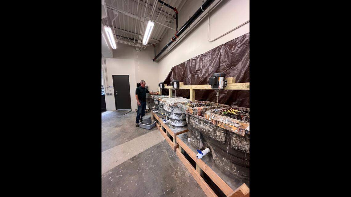 Trent Thompson, environmental programs manager in the county’s Department of Health and Environment, works the reblending machines for latex paint at the county’s new household hazardous waste facility.
