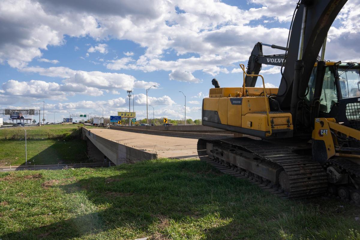 Construction equipment sits at the head of a decommissioned bridge along Truman Road that runs parallel to I-70 on Thursday, April 10, 2025. The bridge is set to be demolished in the coming days.