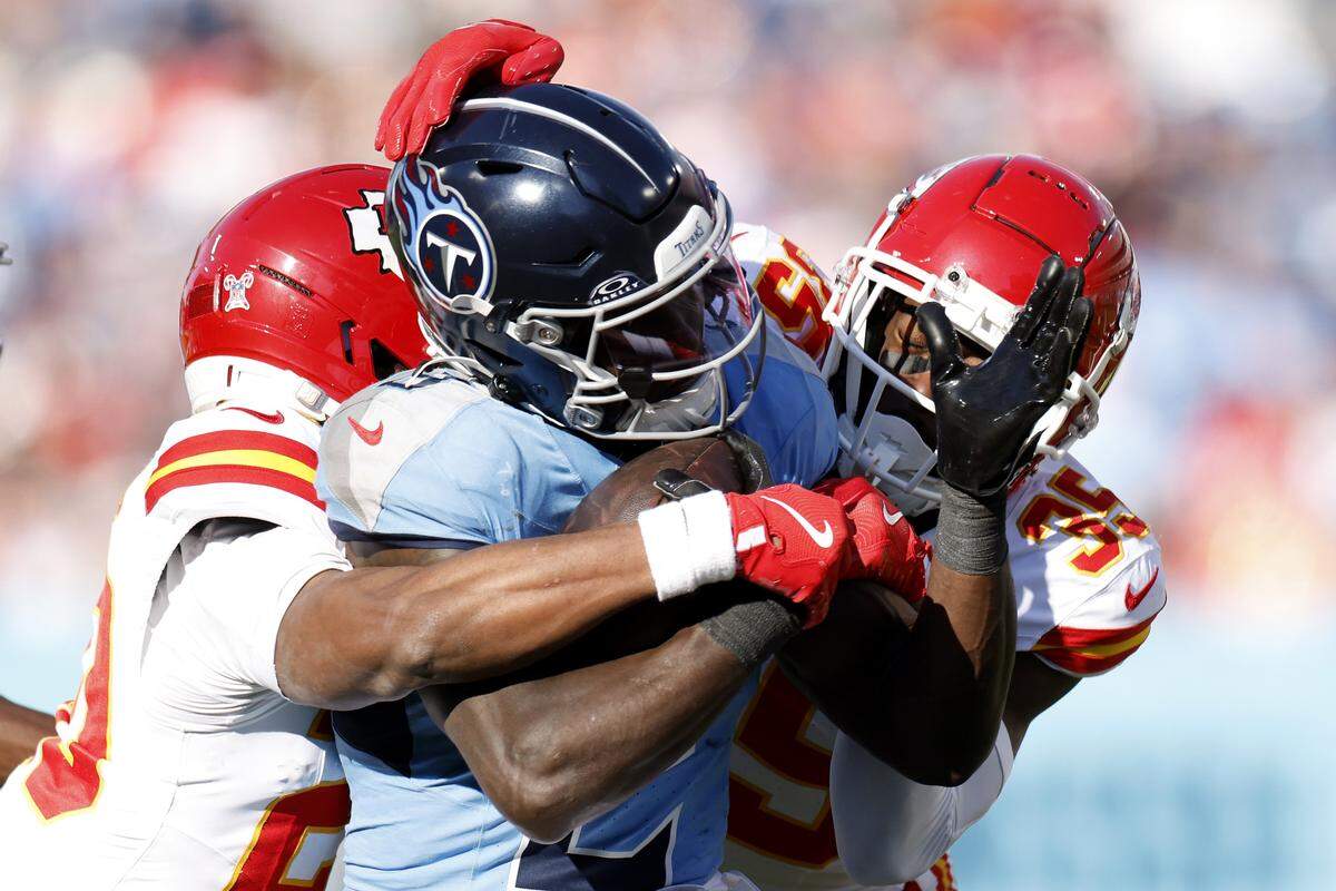 Kansas City Chiefs defenders bring down Titans running back Tyjae Spears during an NFL Week 16 game at Nissan Stadium in Nashville, Tennessee on Sunday, Dec. 21, 2025.