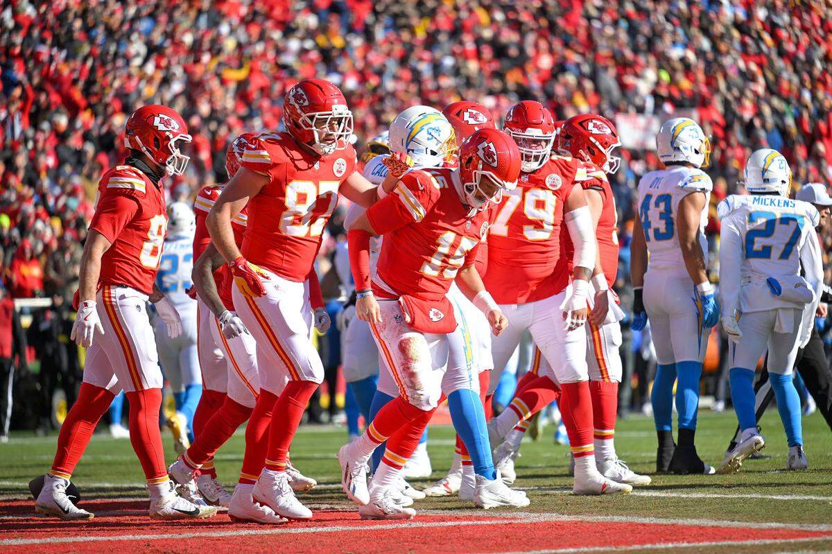 Kansas City Chiefs quarterback Patrick Mahomes (15) and Kansas City Chiefs tight end Travis Kelce (87) celebrate after Mahomes scores a touchdown on the first drive against the LA Chargers at GEHA Field at Arrowhead Stadium on Sunday, Dec. 14, 2025.