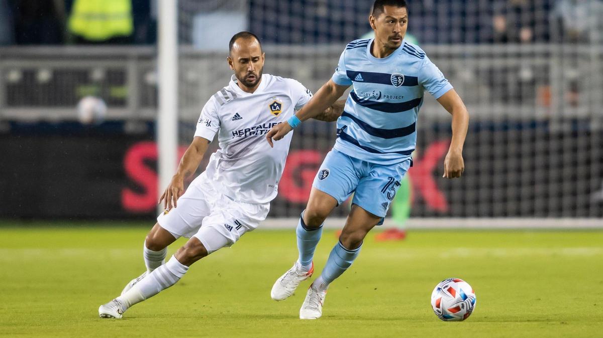 Sporting Kansas City midfielder Roger Espinoza, right, works the ball around Los Angeles Galaxy midfielder Victor Vazquez during an October match at Children’s Mercy Park in Kansas City, Kan.