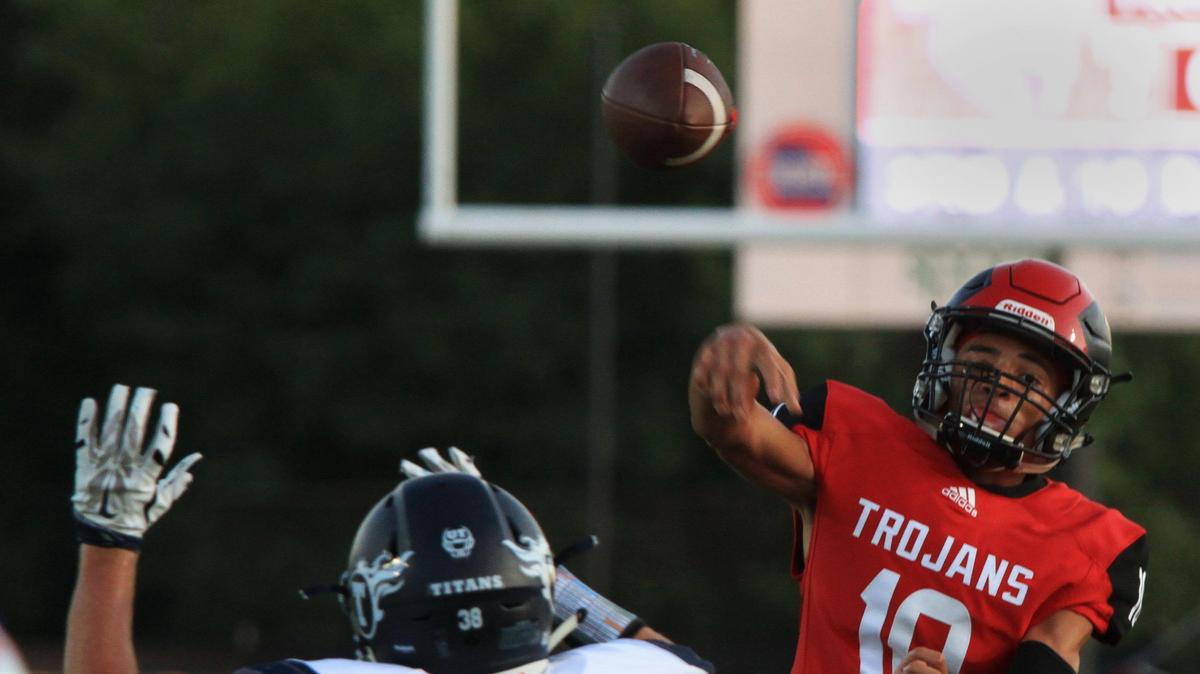 Park Hill quarterback Anthony Hall throws off balance trying to find a target in the end zone against Lee’s Summit West in the first game of the year Friday night at Park Hill.