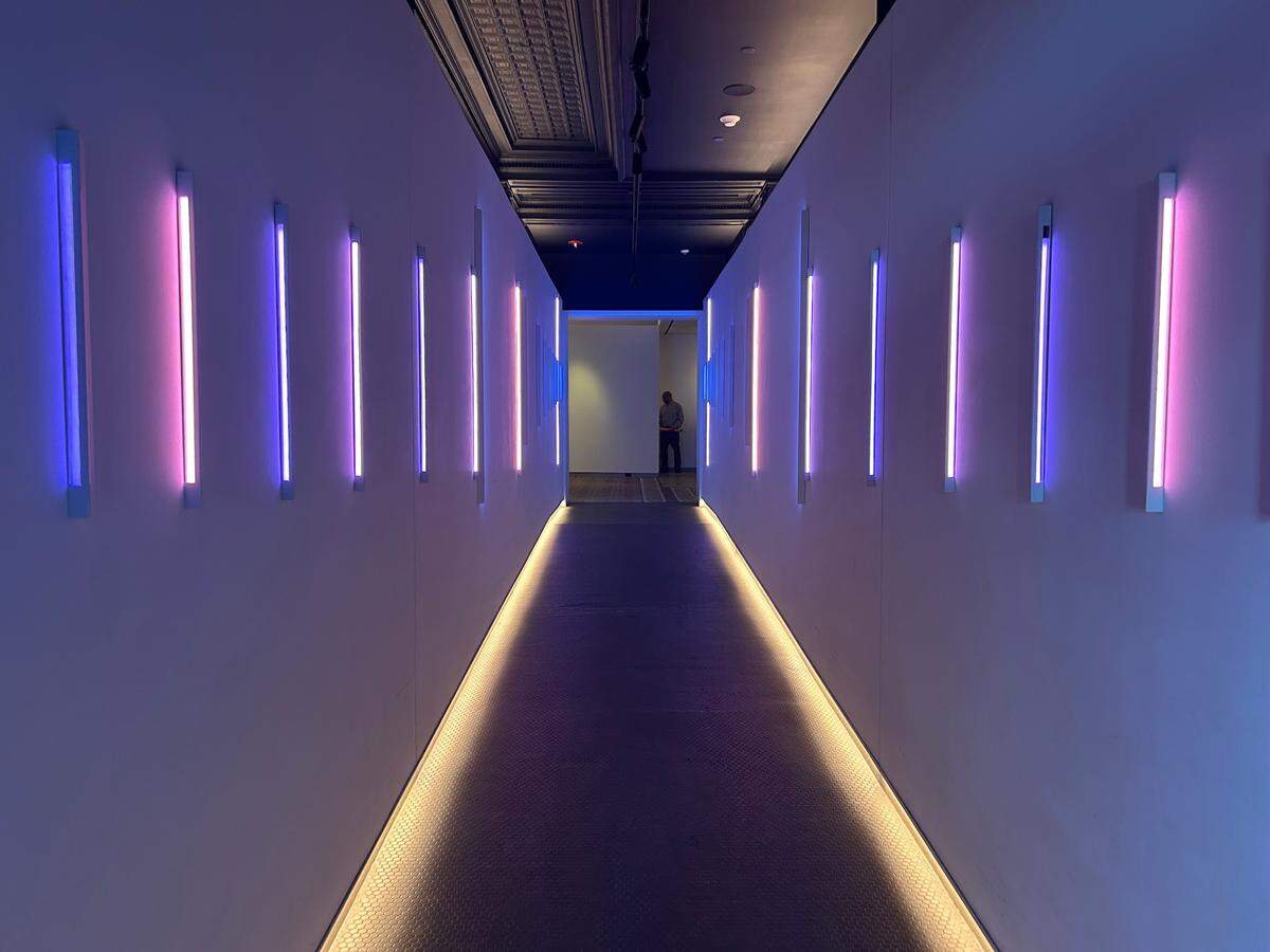 “Linear Sky,” a neon LED light sculpture, greets guests along the walkway ramp into the lobby of the Savoy Hotel, which is now owned by Hilton.