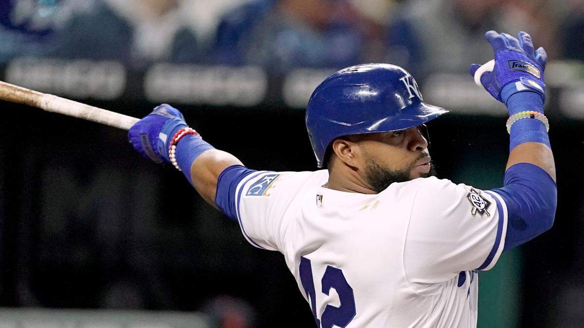 Kansas City Royals’ Carlos Santana hits an RBI single during the fourth inning of a baseball game against the Detroit Tigers Friday, April 15, 2022, in Kansas City, Mo. (AP Photo/Charlie Riedel)