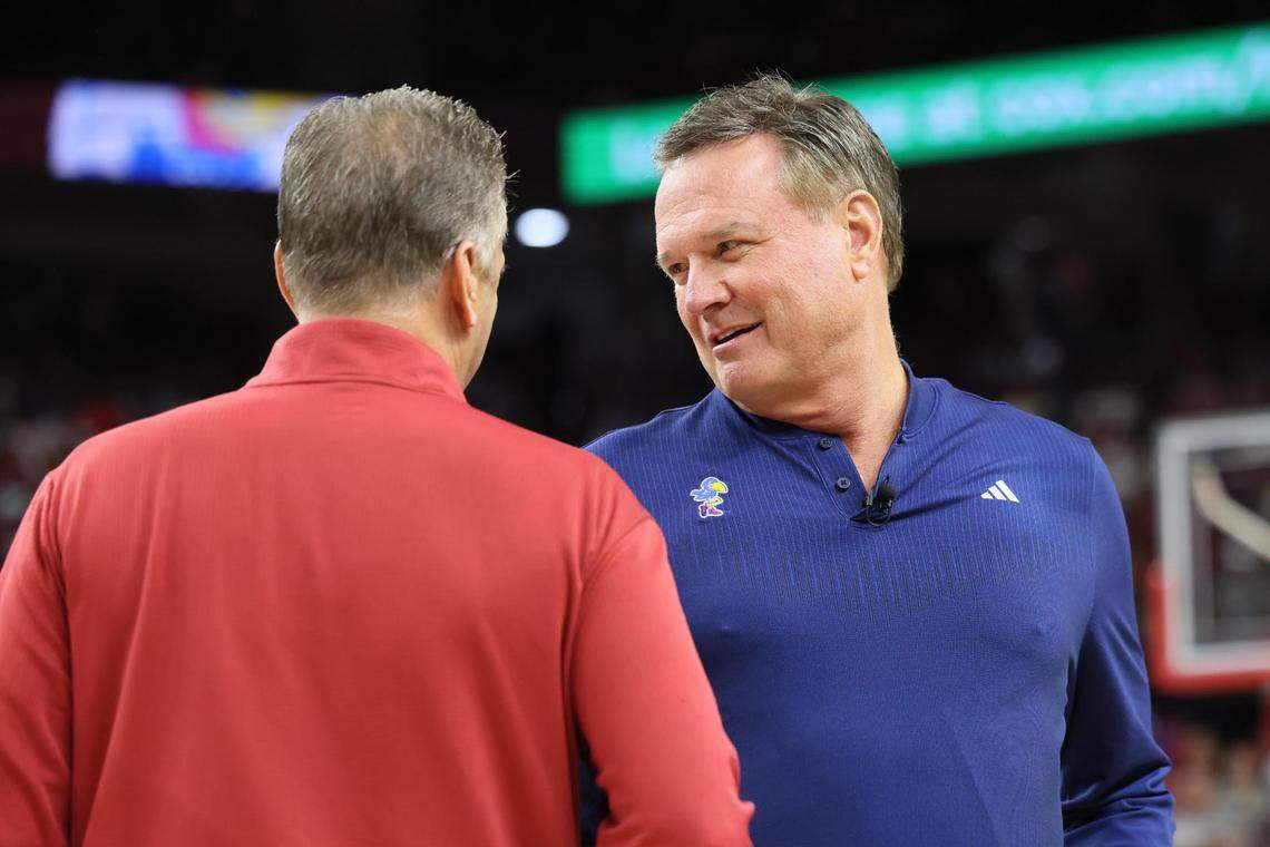 Kansas Jayhawks men’s basketball coach Bill Self, right, greets Arkansas Razorbacks (and former Kentucky) coach John Calipari before Friday evening’s exhibition game at Bud Walton Arena in Fayetteville, Ark.