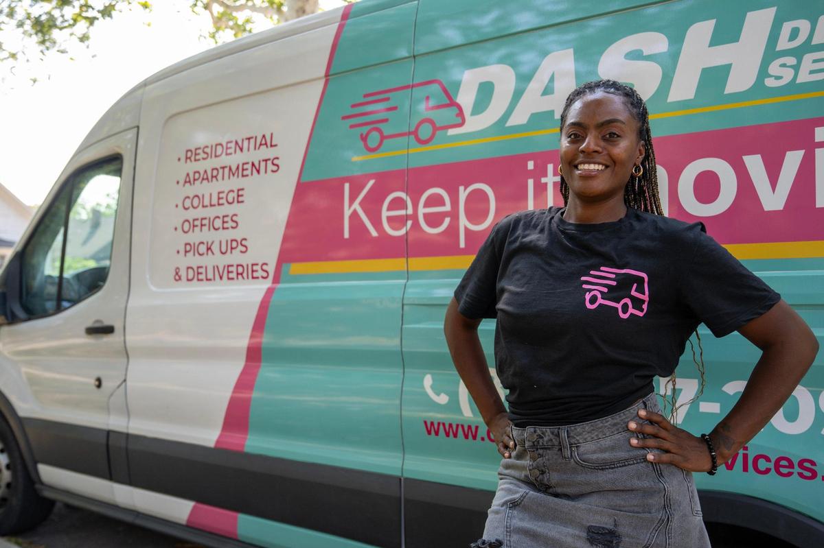 Damesha Cook, owner of Dash Delivery, is seen alongside her van on Thursday, Sept. 7, 2023, in Kansas City.