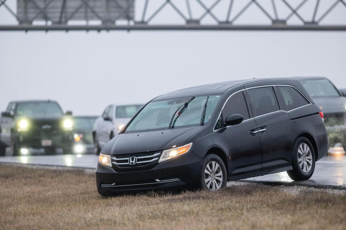 As freezing rain began to move into the area, an icy glaze slowed traffic to a crawl on southbound Interstate 35 near the U.S. 69 Highway exit Saturday, Jan. 4, 2024, in Lenexa. Some drivers opted to exit the highway and drive across the grass to the frontage road.