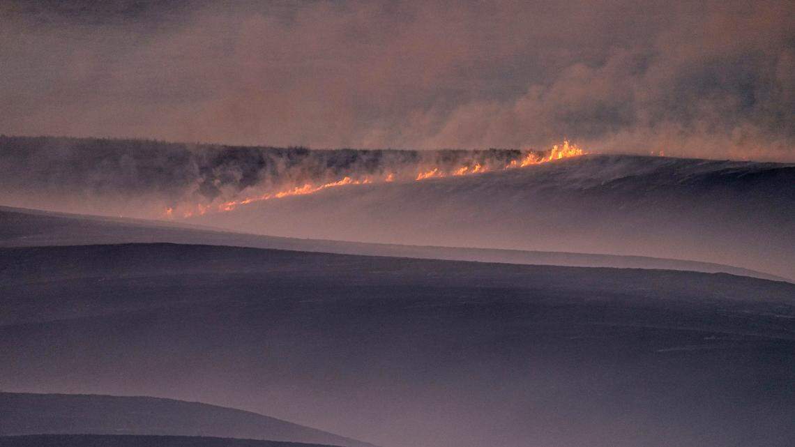 Fires continued to burn in a pasture which was part of a fire that burned and stretched across Ellis, Russell, Osborne and Rooks counties Thursday, Dec. 16, 2021, near Natoma, Kan. The fire was stoked by a storm that passed through the area Wednesday with high winds and gusts up to 90 mph. (AP Photo/Charlie Riedel)