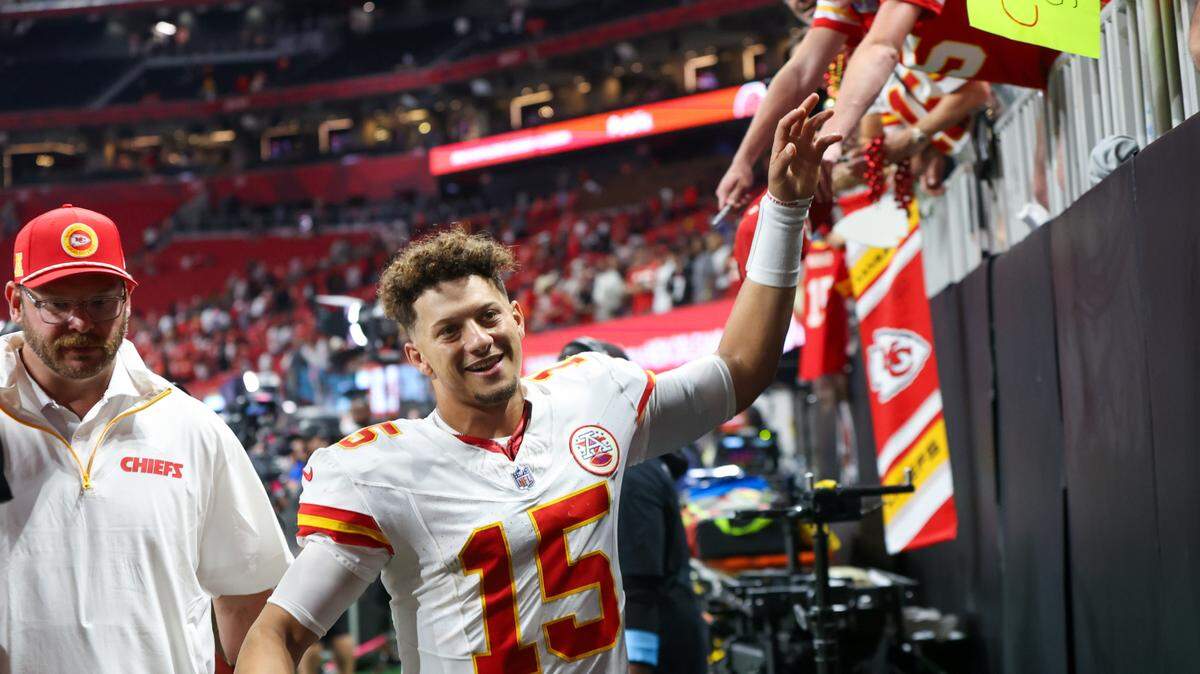 Kansas City Chiefs quarterback Patrick Mahomes (15) high-fives fans after a victory over the Atlanta Falcons at Mercedes-Benz Stadium on Sept. 22, 2024.