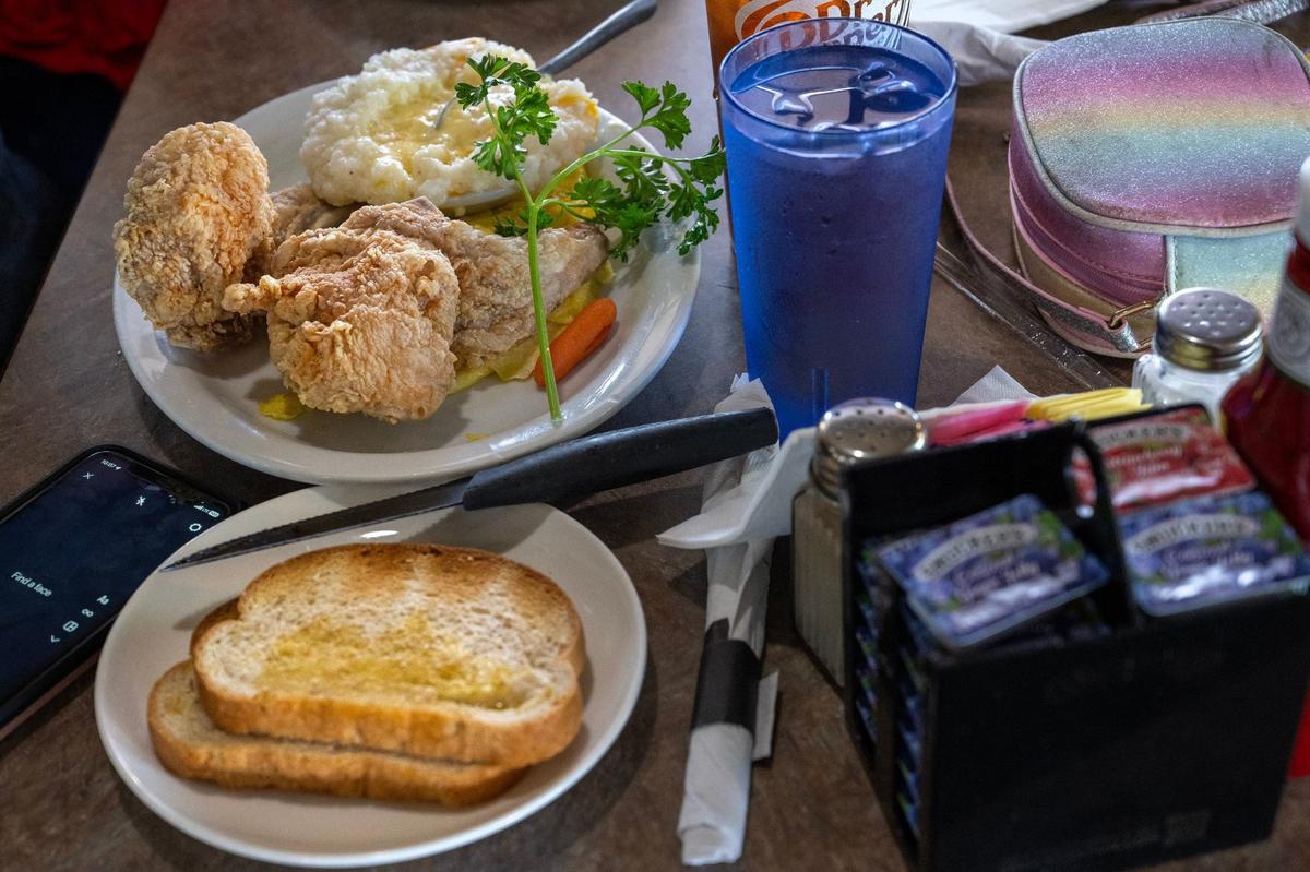 One customer’s mouthwatering order at Niecie’s: fried pork chops, eggs and grits.