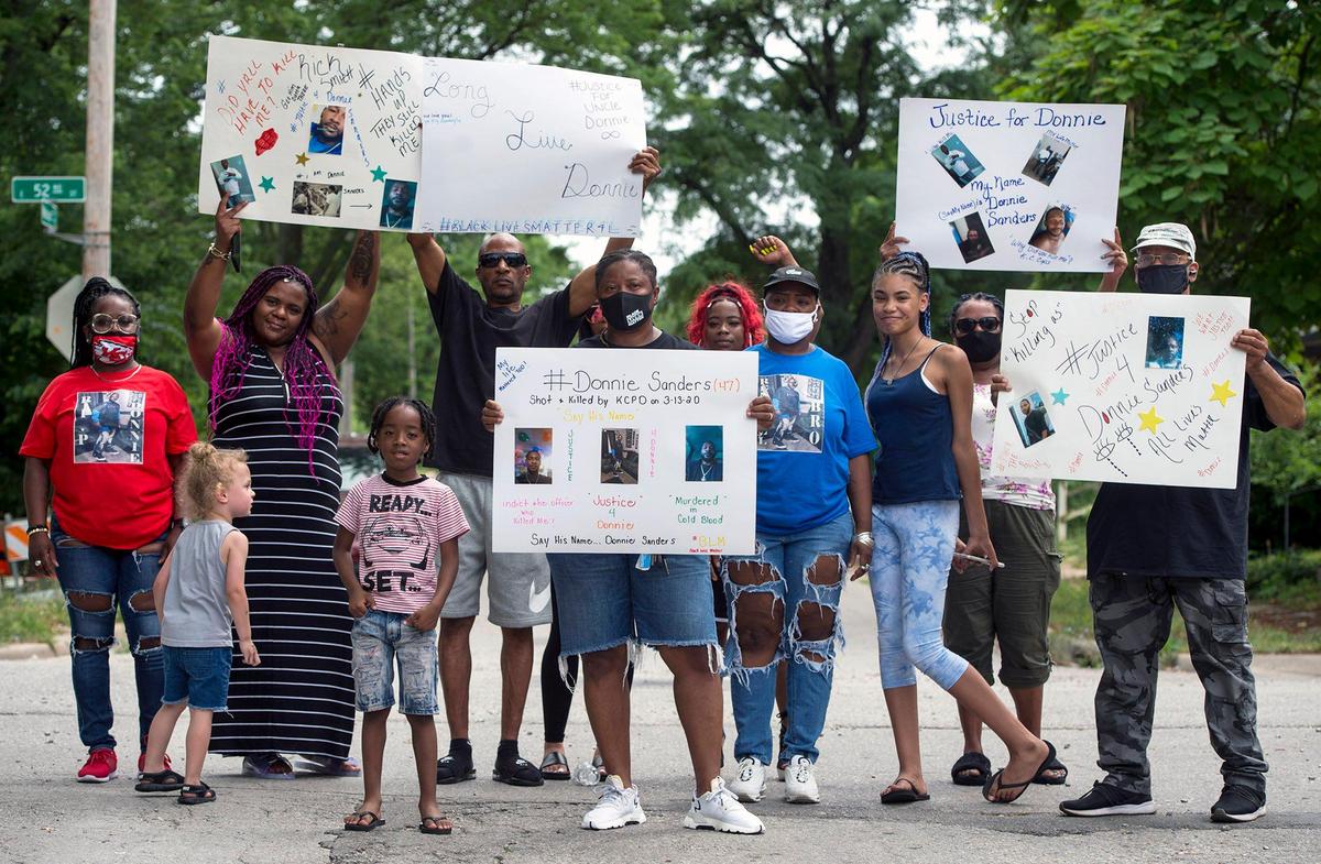 The family of Donnie Sanders, including sisters, Kianna Benton (back, left in red), Youlanda Sanders, (center) and Reshonda Sanders (in front in blue) and others gathered to talk about police brutality and seeking justice for Donnie, 47, who died after being shot by a Kansas City police officer in March. Donnie, who fled on foot after an attempted traffic stop, was shot near E. 52nd Street and Wabash Avenue on March 13 in Kansas City. He was unarmed.
