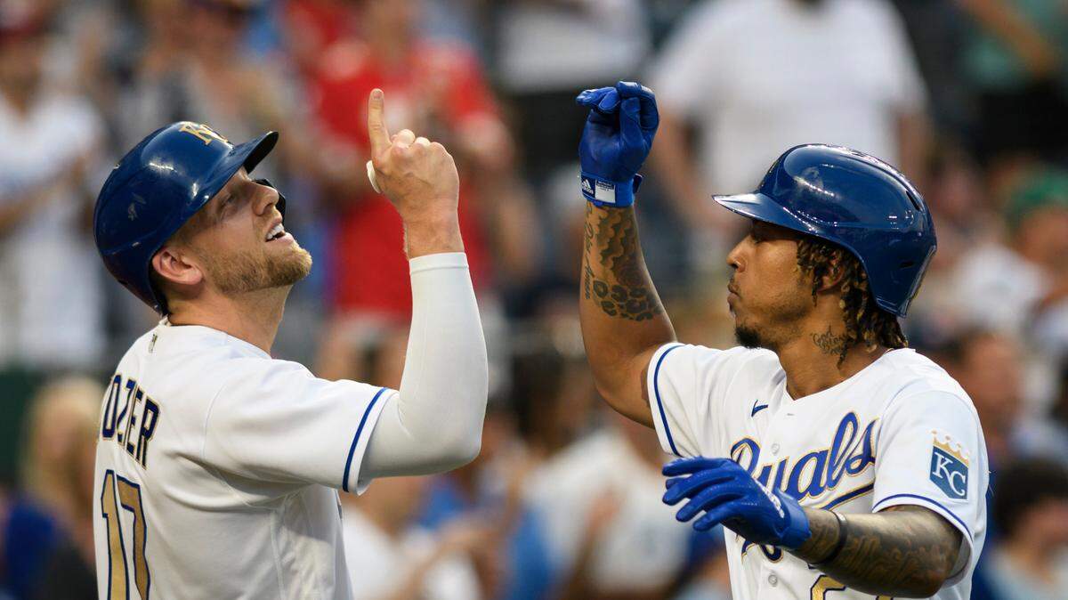 Kansas City Royals’ Hunter Dozier, left, congratulates teammate Adalberto Mondesi on his three-run home run during the third inning of a baseball game against the Boston Red Sox in Kansas City, Mo., Friday, June 18, 2021. (AP Photo/Reed Hoffmann)