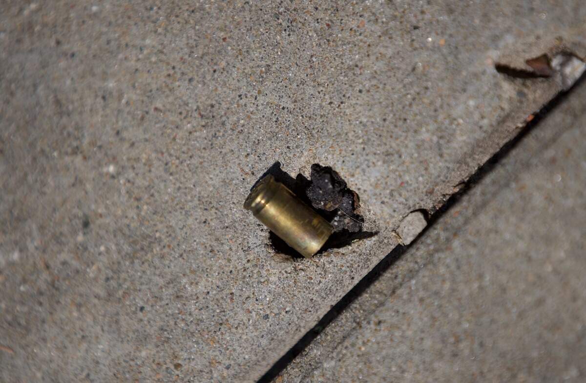 A bullet casing is seen on the sidewalk at 19th and Vine streets on Saturday, June 20. Police said several people were injured and one man was killed in a shooting in the area the night before.