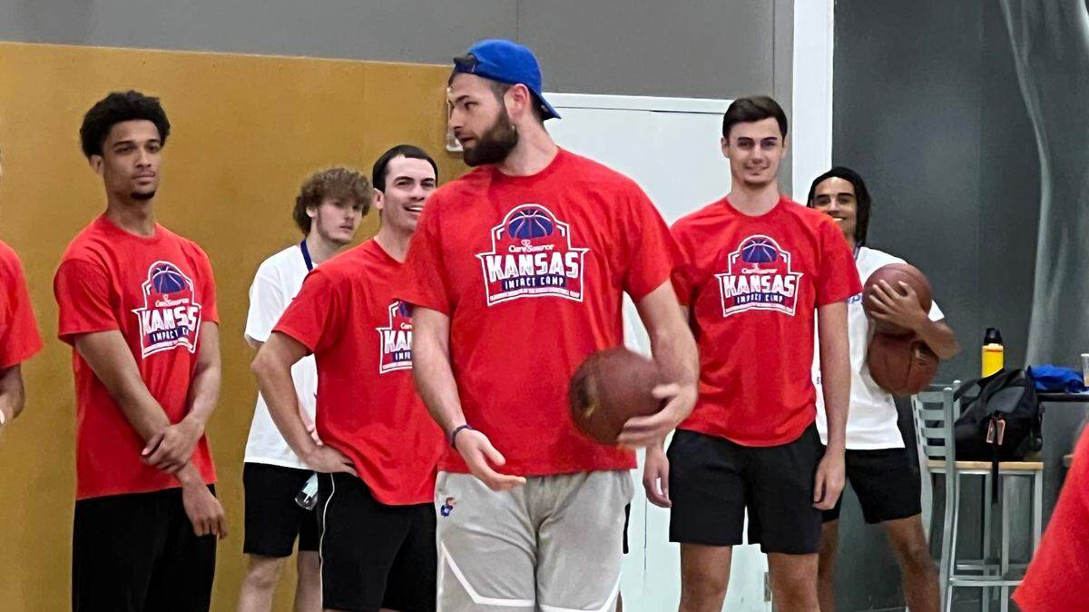 KU forward Hunter Dickinson (front) prepares to instruct youths on making post moves at the CareSource Kansas Impact Camp on Saturday, Sept. 16, 2023, in Gardner.