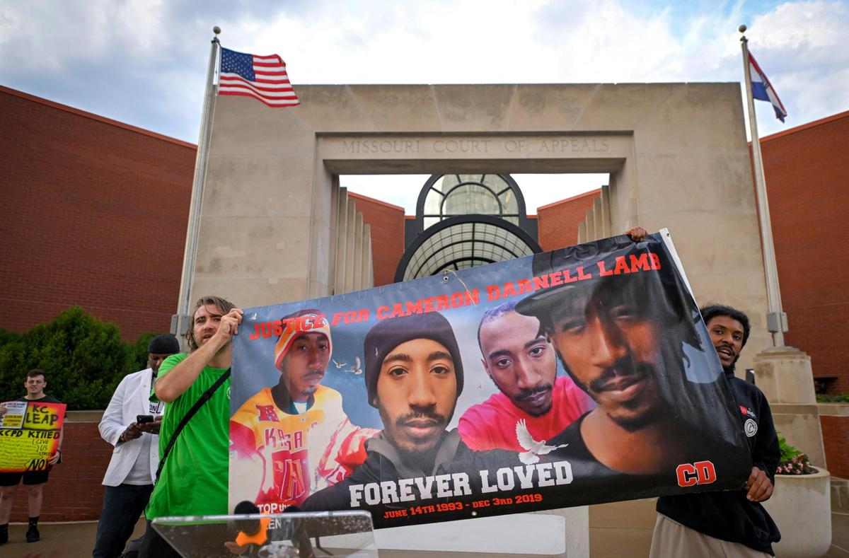 Members of Decarcerate KC, including Dylan Pyles, left, and Lavelle Lee, as well as members of Kansas City Law Enforcement Accountability Project (KCLEAP ) and Urban League of Greater Kansas City, rallied outside the Missouri Court of Appeals, Western District, during a hearing Tuesday, Sept. 5, for Kansas City Police Det. Eric DeValkenaer, who is white, and is seeking a new trial or to have his conviction overturned in the 2019 shooting death of Cameron Lamb, a Black man. DeValkenaer was sentenced to six years in prison after being found guilty of second-degree involuntary manslaughter and armed criminal action in the killing of Lamb on Dec. 3, 2019. The groups want the conviction upheld.
