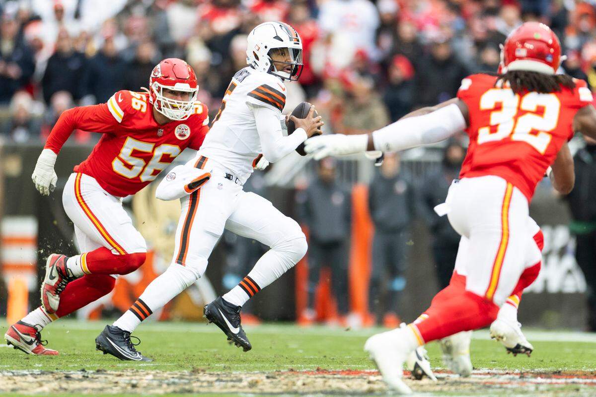 Kansas City Chiefs defensive end George Karlaftis, left, and linebacker Nick Bolton, right, keep an eye on Cleveland Browns quarterback Jameis Winston (No. 5) during a Week 15 NFL game at Huntington Bank Field in Cleveland, Ohio on Sunday, Dec. 15, 2024.