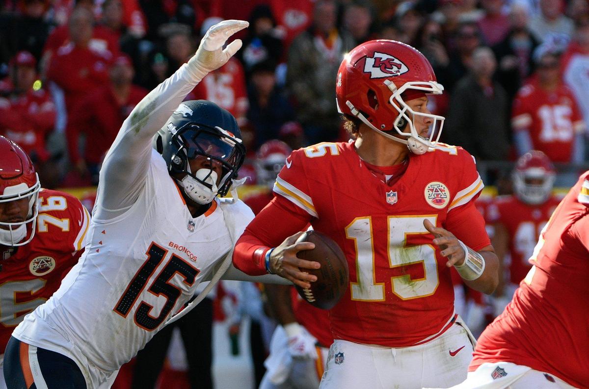 Denver Broncos linebacker Nik Bonitto (15) nearly had Kansas City Chiefs quarterback Patrick Mahomes (15) in his grasp in the second half but Mahomes was able to evade the defense and avoid another sack on Sunday, Nov. 10, 2024, at GEHA Field at Arrowhead Stadium.