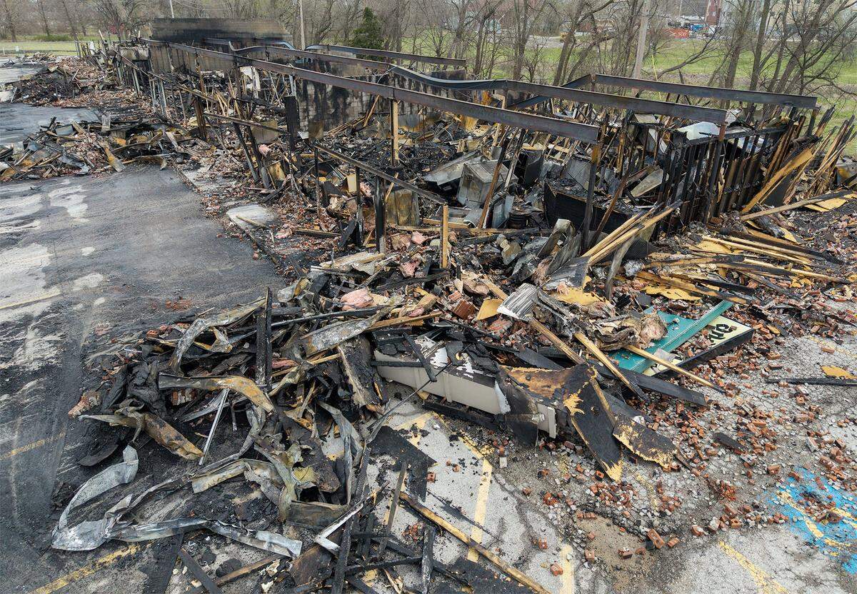 The skeletal remains of a Smithville shopping center stand in ruin on Tuesday, March 31, 2026, less than 24 hours after a massive fire destroyed five businesses. The Monday afternoon blaze destroyed Smithville's Pizza Shoppe, La Fuente Mexican Restaurant, H&R Block, Westlake Chinese Restaurant, and Lakeside Smoke.