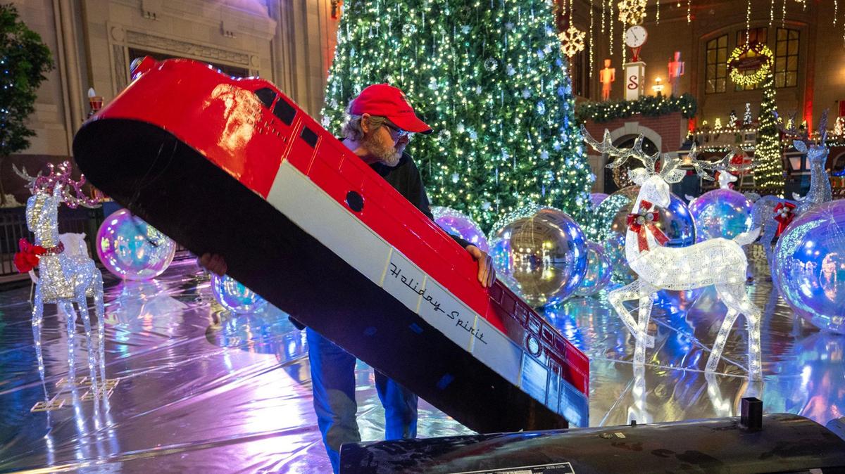 Steve Uhlir of Cleveland, Ohio, worked on the Holiday Spirit train setup for the Holiday Reflections display at Union Station’s Grand Plaza.